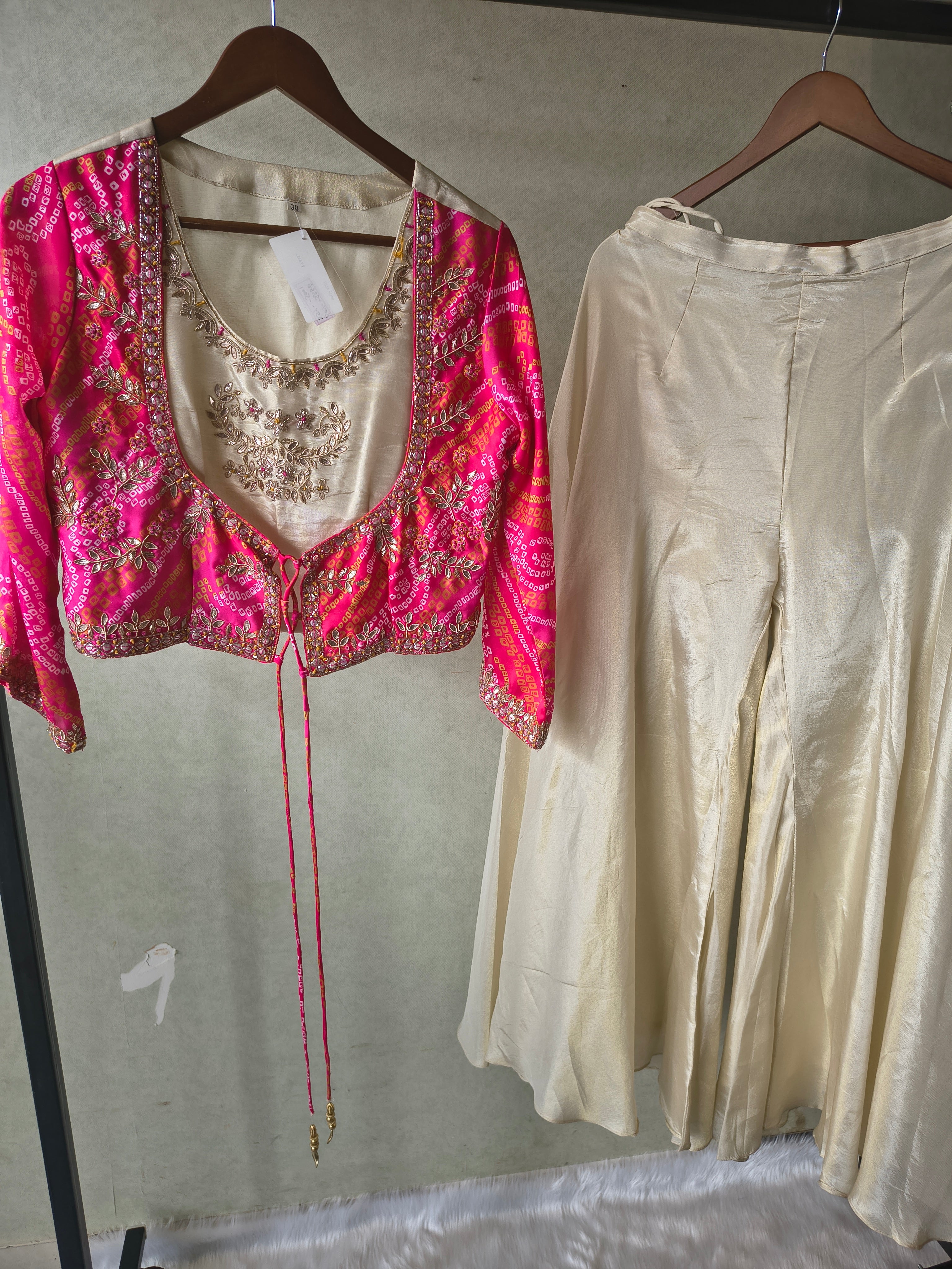 Image of Premium Hot Pink Bandhani Print Embroidered Jacket Blouse with Ivory Flared Palazzo Set