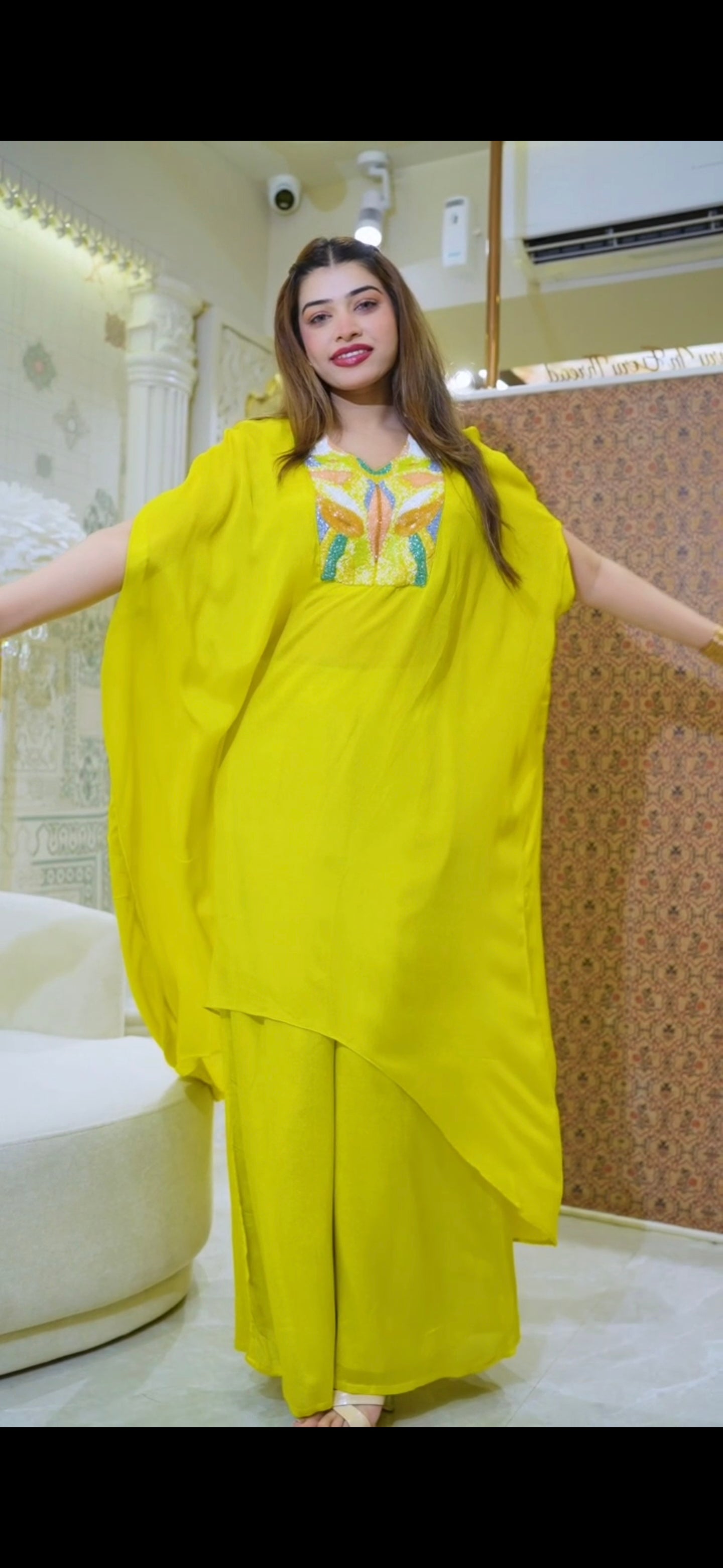 Glow in this stunning pure fabric 2-piece Indo-Western set in radiant yellow & Long Kaftan-style Top with detailed center handwork