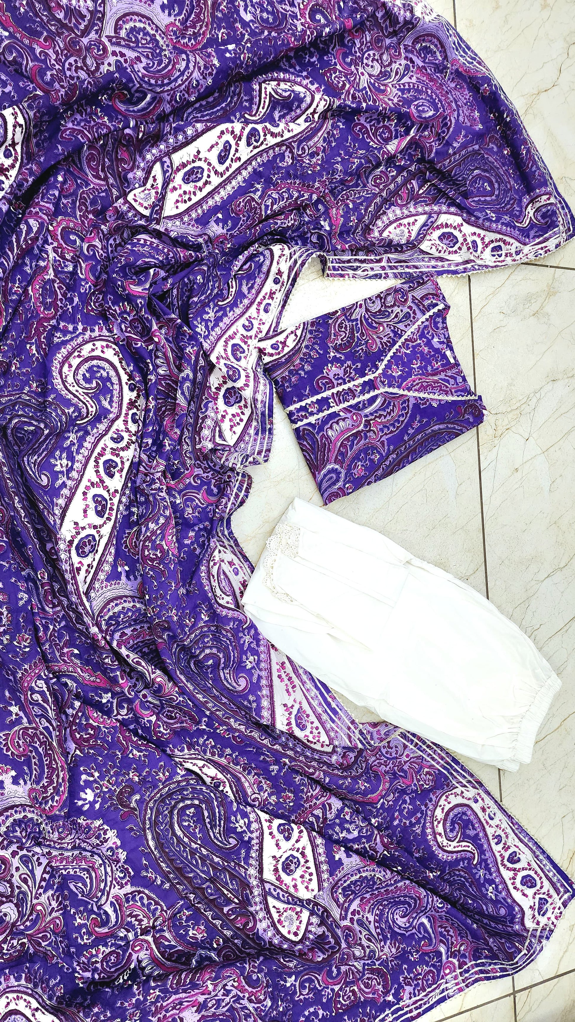 This is a three piece lawn paisley print suit set. The set includes Kurta, Tulip Pants and Dupatta