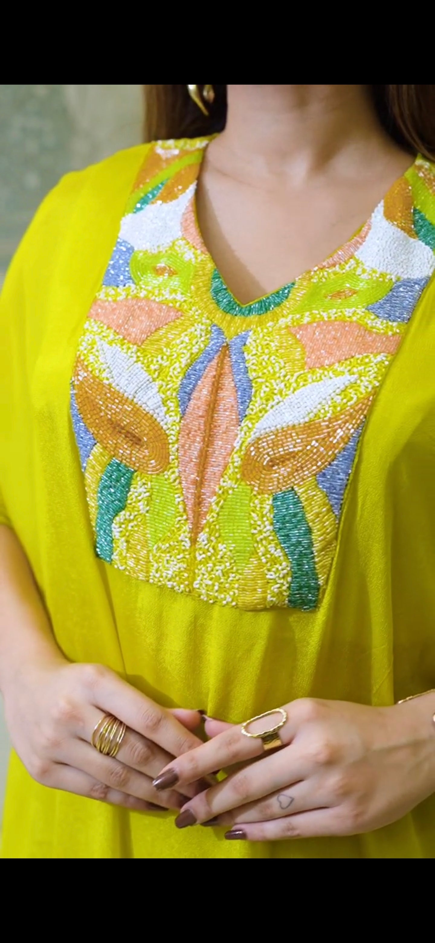 Glow in this stunning pure fabric 2-piece Indo-Western set in radiant yellow & Long Kaftan-style Top with detailed center handwork